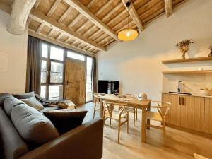 a living room with a couch and a table at Torre Medieval de Queralt y Spa in Concabella