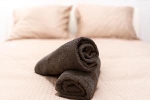 a towel sitting on top of a bed at Central Seven Erzsebet Krt in Budapest