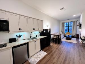 a kitchen with white cabinets and a living room at Mountain Creek Resort at Appalachian Hotel - Pool & Hot Tub in Vernon Township