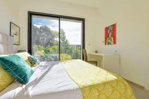 a bedroom with a bed and a large window at Le Jardin de Lina in La Marsa +5 photos