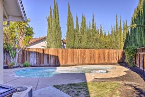 a backyard with a wooden fence and a swimming pool at Modesto Home with Deck - 2 Mi to Vintage Faire Mall in Modesto