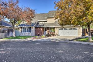a house with a driveway with a garage at Modesto Home with Deck - 2 Mi to Vintage Faire Mall in Modesto