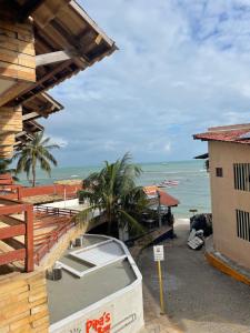 a boat on a street next to a beach at Pipa's Bay - Flats para temporada in Pipa