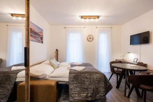 a hotel room with a bed and a table and a desk at Central Sphere Apartment in Budapest