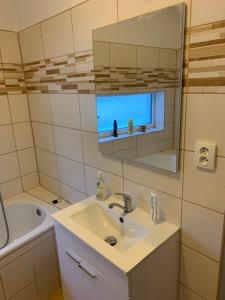 a bathroom with a sink and a mirror and a tub at U lesního muže in Střelice +56 photos