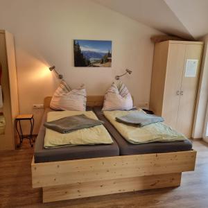 2 camas sentadas en una plataforma de madera en una habitación en Das Taubenhaus, en Hollersbach im Pinzgau