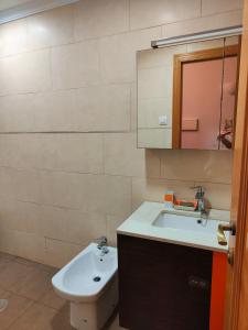 a bathroom with a sink and a toilet and a mirror at Estrella azul/ Blue star in Puerto de Sagunto +16 photos