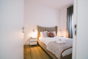 a bedroom with a bed and a night stand with two lamps at Best Houses 30 - Terrace Peniche in Peniche