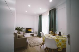 ein Wohnzimmer mit einem Esstisch und einem TV in der Unterkunft Best Houses 30 - Terrace Peniche in Peniche