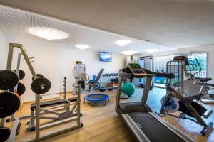 a gym with several treadmills and exercise equipment at Mölgg Dolomites Residence in San Vigilio Di Marebbe