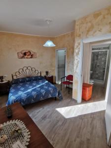 a bedroom with a bed and a living room at Il Torrione in Poggio Bustone