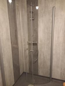 a shower with a glass door in a bathroom at Ristafallet in Åre