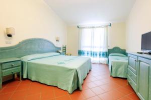Postel nebo postele na pokoji v ubytování Hotel Baia Aranzos + 17 fotografií