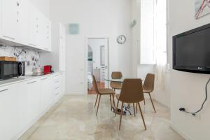 uma cozinha e sala de jantar com mesa e cadeiras em HC Home Claudia em Cagliari