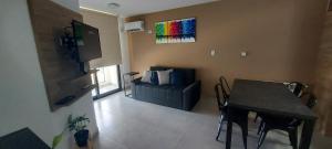 a living room with a table and a couch at Centro Carlos Paz 1 dormitorio in Villa Carlos Paz