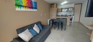 a living room with a couch and a dining room at Centro Carlos Paz 1 dormitorio in Villa Carlos Paz