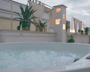 a jacuzzi tub on the balcony of a house at Lunà - Le Dimore - in Canosa di Puglia