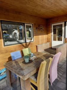 a wooden table and chairs on a patio at 't uiltje in Ermelo