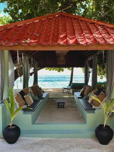 a gazebo with pillows on the beach at Canopus Retreat Thulusdhoo in Thulusdhoo