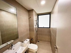 a bathroom with a toilet and a sink and a window at Cozy & Comfy Home Dsara Sentral Opposite MRT in Sungai Buluh