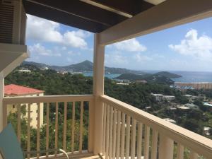 a balcony with a view of the ocean at Sunset Gardens Guesthouse in Charlotte Amalie