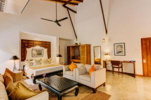 a large living room with a bed and a table at Aditya Boutique Hotel in Hikkaduwa