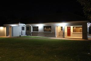 a house with lights on the side of it at night at A pristine BB located in Belvedere Harare - 2010 in Harare
