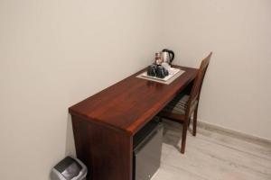a wooden desk with a tea kettle on top of it at A pristine BB located in Belvedere Harare - 2010 in Harare