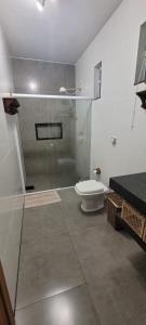 a bathroom with a glass shower and a toilet at Casa de campo em São Thomé das Letras in São Thomé das Letras +17 photos