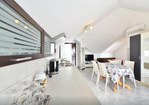 a kitchen and dining room with a table and chairs at Apartments Sanda 2 in Promajna