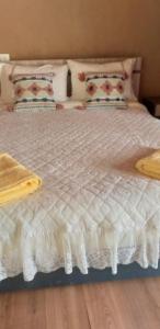 a white bed with pillows on top of it at Hospedaje Rural Casa de Felix in San Pedro de Atacama