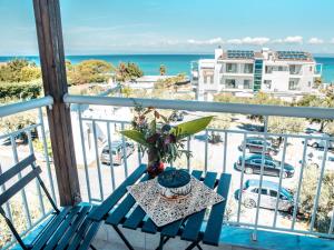 a table on a balcony with a view of the ocean at Anastasia Mare Studios in Pefkochori