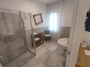 a bathroom with a shower and a sink at fuORIOrbita in Orio al Serio +8 photos