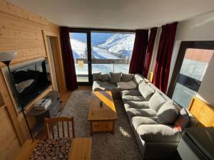 a living room with a couch and a large window at Appart 4 pièces, 10 pers, au pied des pistes, Les Menuires, animaux admis, wifi - FR-1-574-3 in Les Menuires
