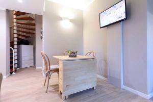 a dining room with a table and a tv on a wall at Agriturismo Tenuta "Il Cigno" in Villanterio