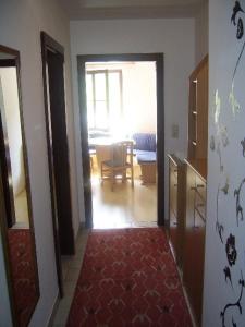 a hallway leading to a living room with a table at Pension Post - Sistrans in Innsbruck