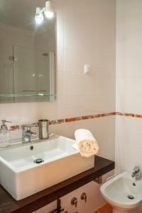 a white bathroom with a sink and a mirror at Best Houses 06 - Gorgeous - Stunning Sea View in Ferrel