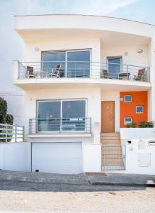 a white house with a balcony at Best Houses 06 - Gorgeous - Stunning Sea View in Ferrel