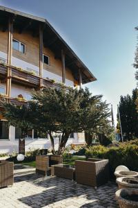 a tree in front of a building at Wellnesshotel Paradiesquelle in Puchberg am Schneeberg