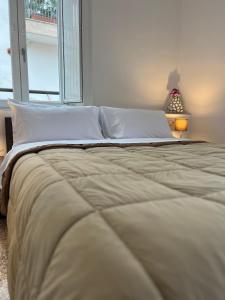 a large bed with white sheets and pillows in a bedroom at Bonadies64 B&B in Salerno