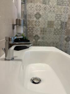 a white sink with a faucet on top of it at Bonadies64 B&B in Salerno