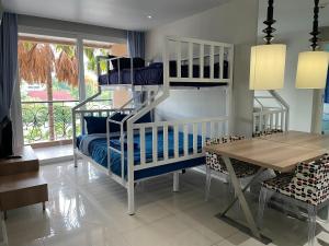 a childs bedroom with a bunk bed and a table at Atlantis Condo Resort jomtien in Jomtien Beach