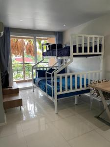 two bunk beds in a room with a window at Atlantis Condo Resort jomtien in Jomtien Beach