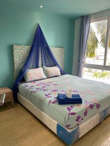 Postel nebo postele na pokoji v ubytování Atlantis Condo Resort jomtien