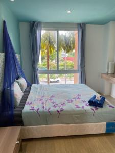 Postel nebo postele na pokoji v ubytování Atlantis Condo Resort jomtien