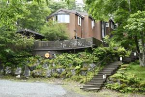 uma casa com escadas que levam até ela em guest house windy em Yamanakako