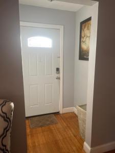 a hallway with a white door and a chair at Three Bed One Bath Apt 25 mins to NYC in Belleville