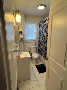 a small bathroom with a toilet and a sink at Three Bed One Bath Apt 25 mins to NYC in Belleville