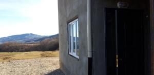 a door to a building with a view of a mountain at Шахдаг in Qusar