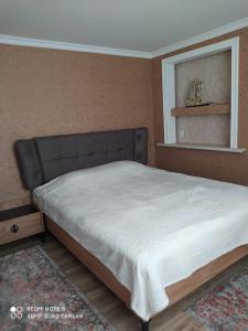 a bedroom with a large bed with a mirror at Шахдаг in Qusar